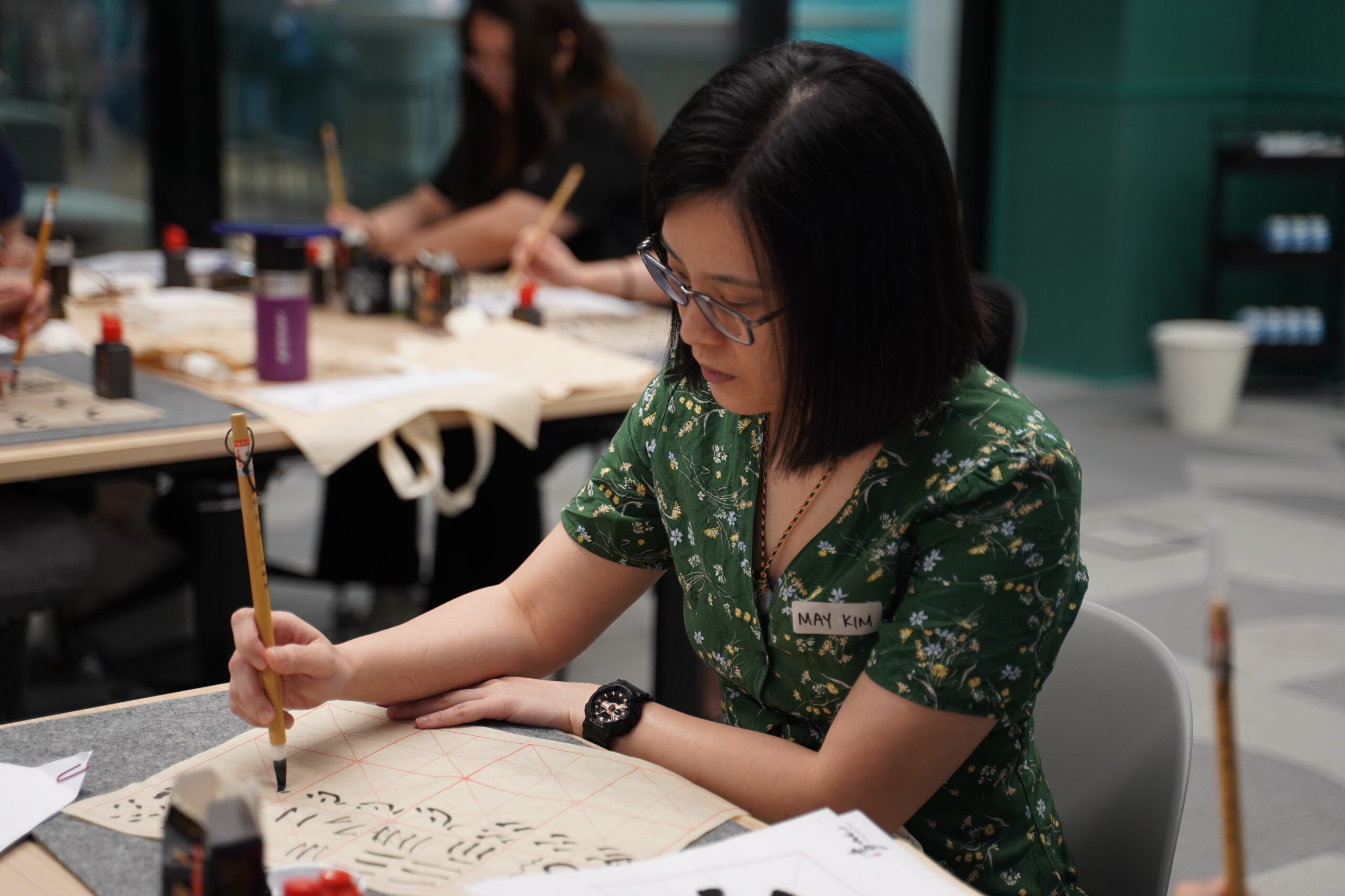 Some close ups of our SITizen practicing the strokes and dots of the Chinese characters.