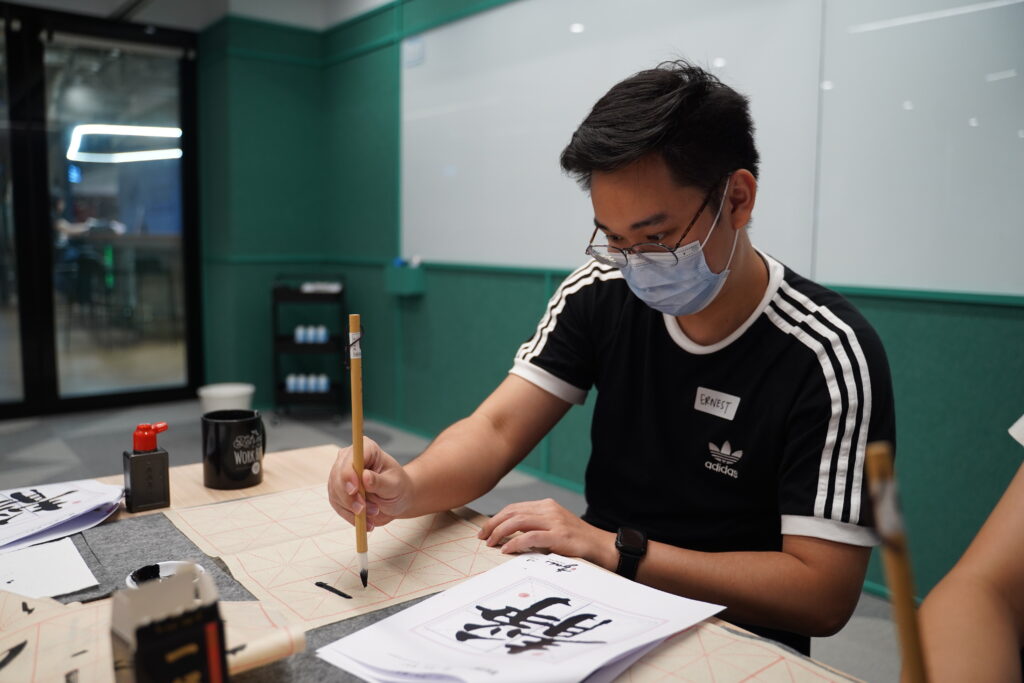 Some close ups of our SITizen practicing the strokes and dots of the Chinese characters.